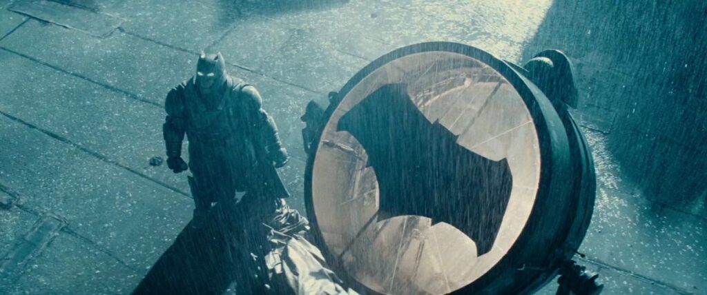 Ben Affleck's Batman stands beside his bat-signal